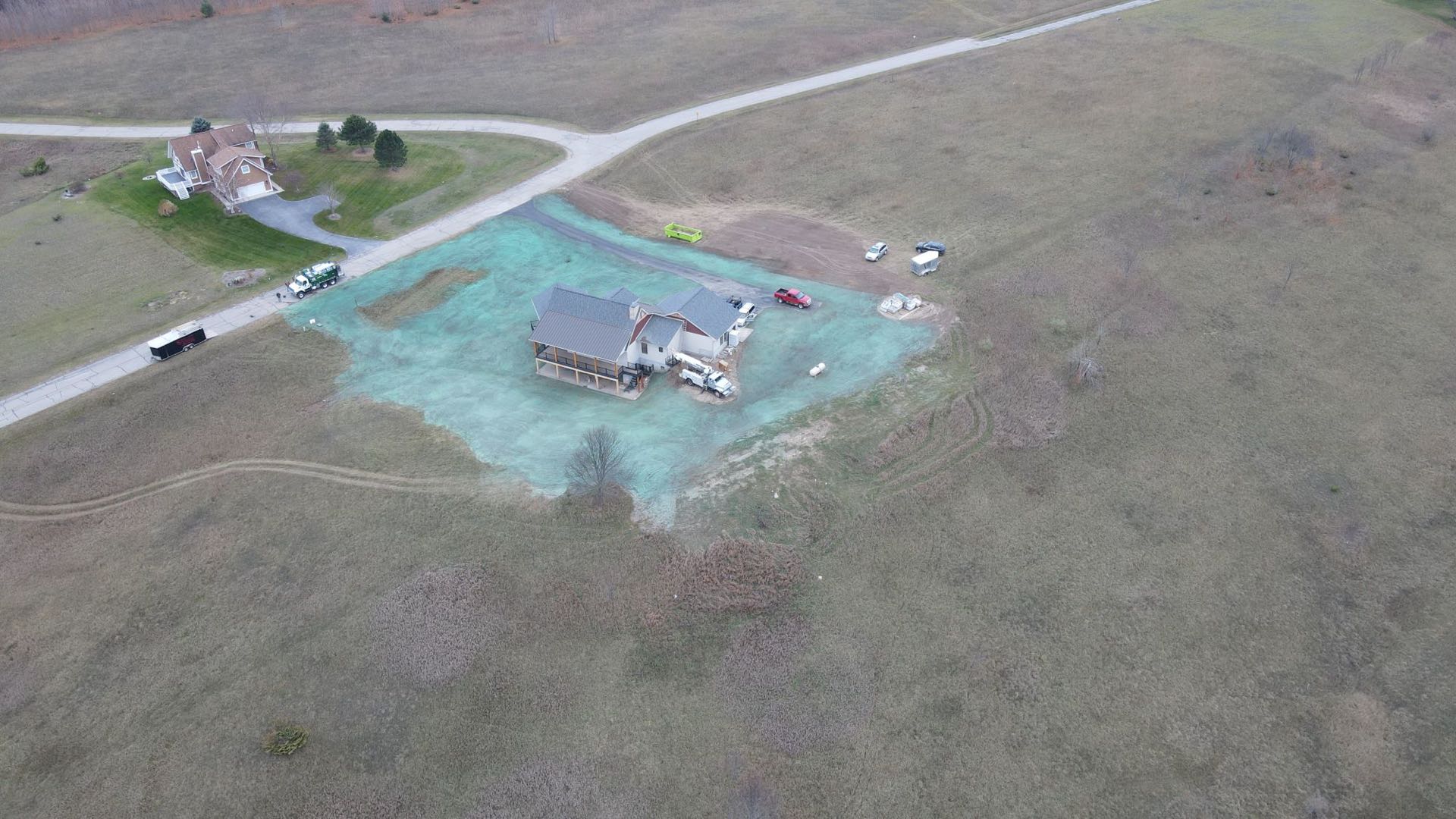 Newly built home with a freshly hydroseeded lawn and North Bay equipment on site
